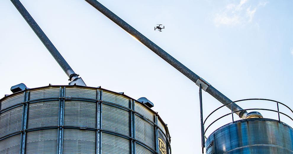 Drone flying over grain bins